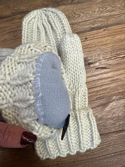 Cream cable knit mitten with gray suede-like palm patch and cuff fold-over