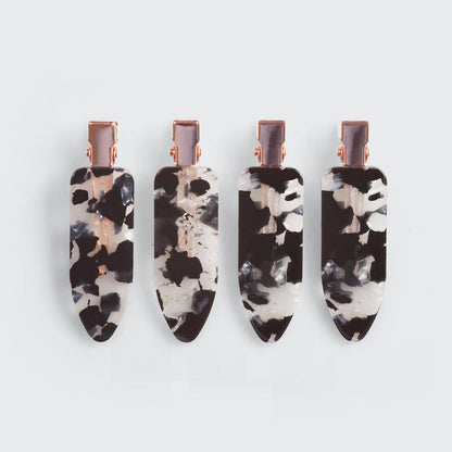 Four tortoise print creaseless hair clips shown from the front on a gray background.