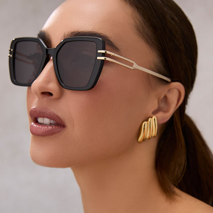 on model - female wearing diff eyewear featuring the dasha square sunglasses with a black frame and grey lenses side view