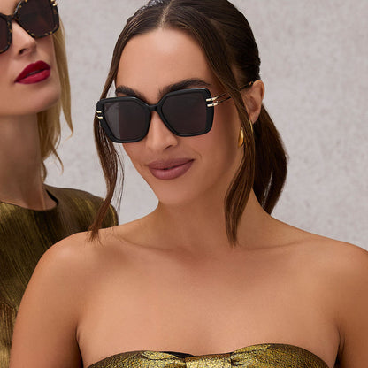 on model - female wearing diff eyewear featuring the dasha square sunglasses with a black frame and grey lenses front view