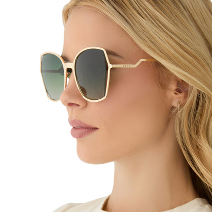 on model - female wearing diff eyewear featuring the donna iii square sunglasses with a gold frame and cool matcha gradient polarized lenses side view