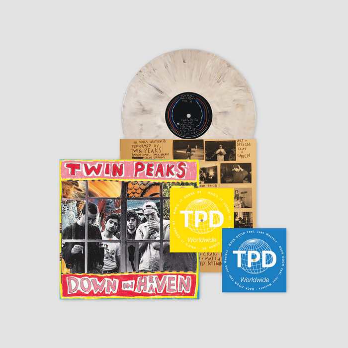 Vinyl record with Twin Peaks album cover and promotional materials on a light gray background