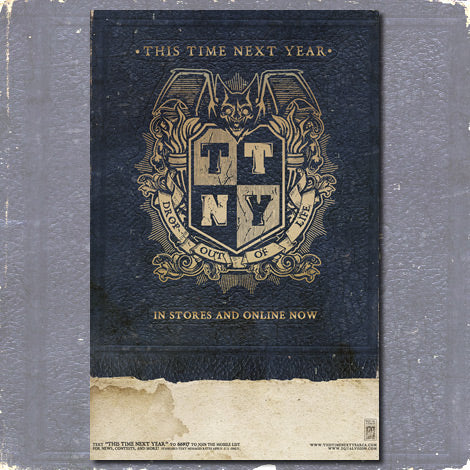 An ornate 11x17 poster in dark blue and gold from This Time Next Year features a crest with a bat, shield, bold TTNY letters, and "This Time Next Year" text. "In stores and online now." Distressed print texture.