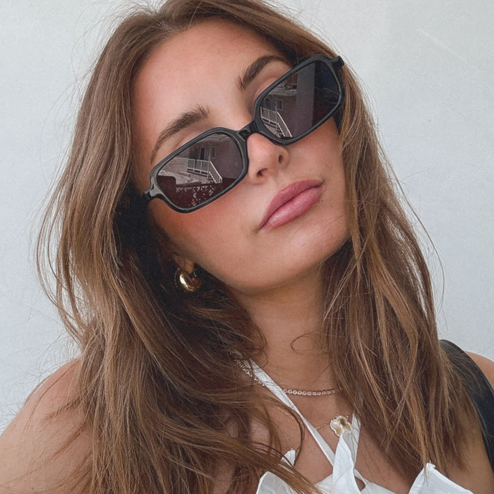 lifestyle - aspyn ovard x diff eyewear featuring the elle rectangle prescription glasses with a black frame and prescription grey lenses front view