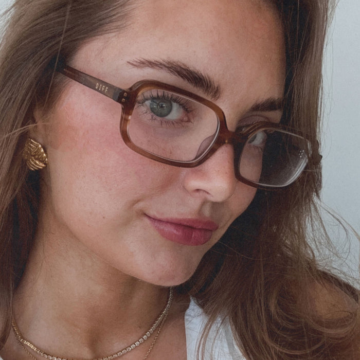 on model - aspyn ovard female wearing aspyn ovard x diff eyewear featuring the elle rectangle prescription glasses with a tortoise frame angled view