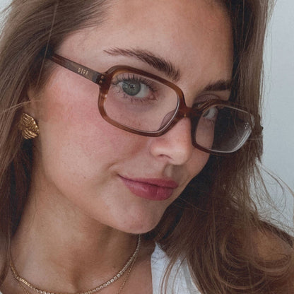 on model - aspyn ovard female wearing aspyn ovard x diff eyewear featuring the elle rectangle prescription glasses with a tortoise frame angled view