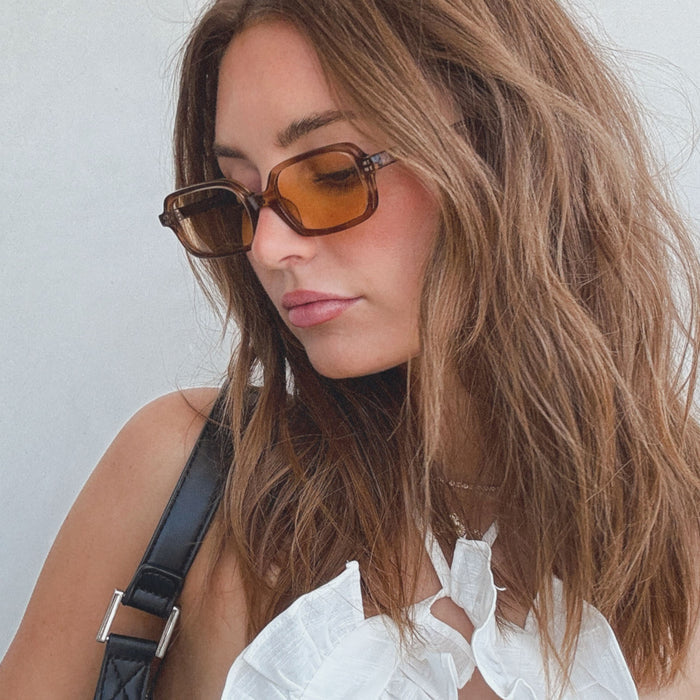lifestyle - aspyn ovard x diff eyewear female wearing the elle rectangle prescription glasses with a tortoise frame and brown prescription lenses angled view