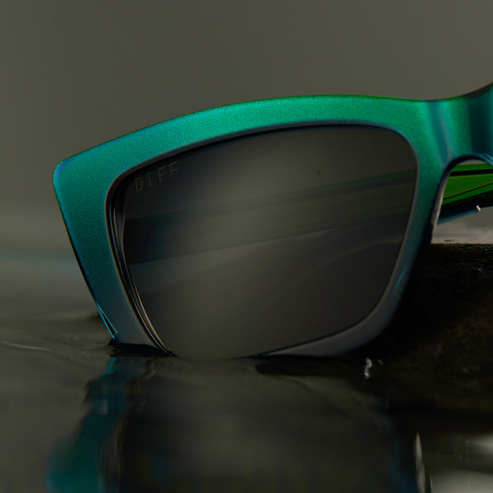 lifestyle - wicked x diff eyewear featuring the elphaba emerald square sunglasses with a black green gradient frame and grey lenses detailed front view