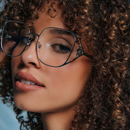 on model - female wearing frozen x diff eyewear featuring the elsa oversized square prescription glasses with a cool silver gloss metal frame angled view