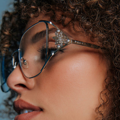 on model - female wearing frozen x diff eyewear featuring the elsa oversized square prescription glasses with a cool silver gloss metal frame detailed temple view