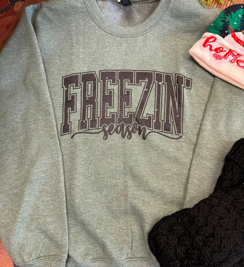 Light gray sweatshirt with large 'FREEZIN' logo and red cursive text