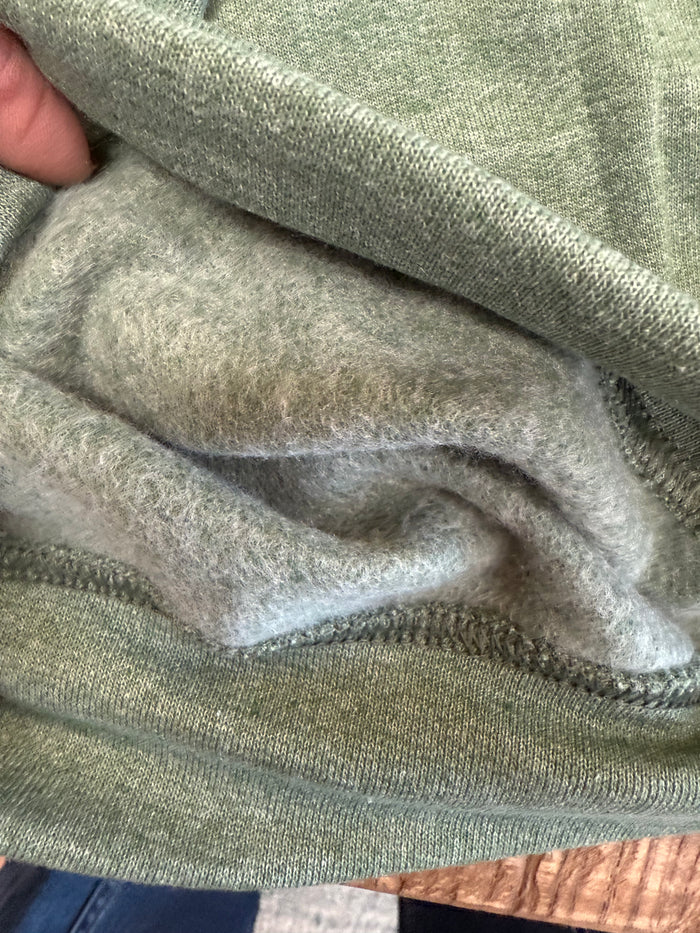 Light gray sweatshirt sleeve cuff and hem stitching close-up