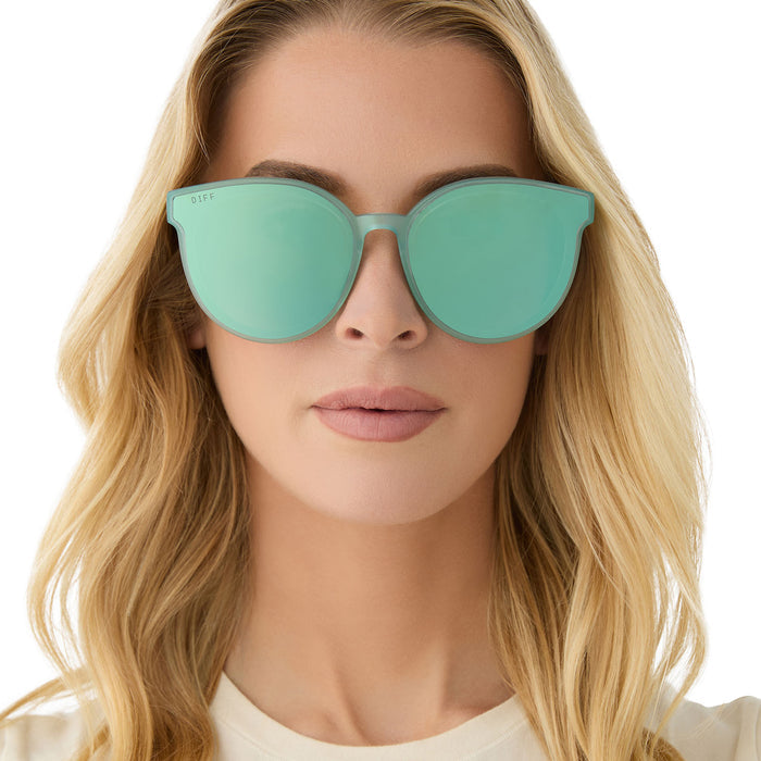 on model - female wearing diff eyewear featuring the gemma round sunglasses with a aquatic awe teal frame and aquatic awe teal mirror lenses front view