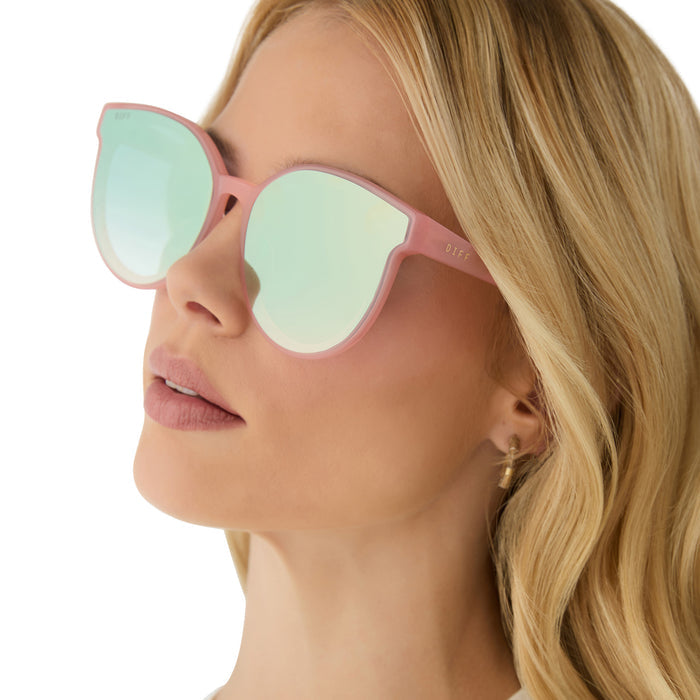 on model - female wearing diff eyewear featuring the gemma round sunglasses with a peach frame and cool matcha gradient mirror lenses side view