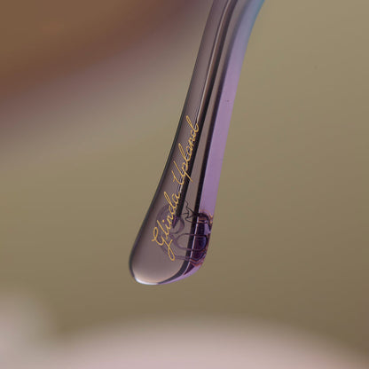 lifestyle - wicked x diff eyewear featuring the glinda upland butterfly cat eye sunglasses with a blue pink gradient frame and blue to pink lenses detailed view of temple tip with glinda upland's name