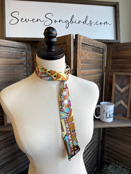Geometric twilly scarf with multicolor abstract building and circular motifs