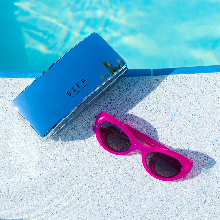still life of diff eyewear chrome case with zaria bright tulip near a pool