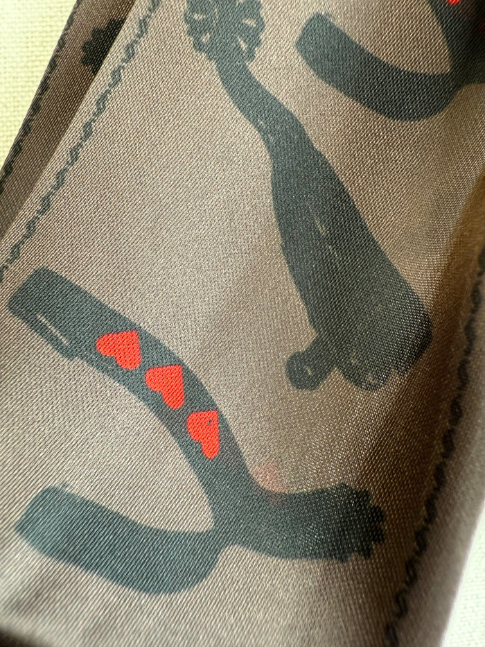 Twilly scarf with dark teal horseshoe pattern and small red heart motifs
