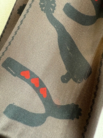 Twilly scarf with dark teal horseshoe pattern and small red heart motifs