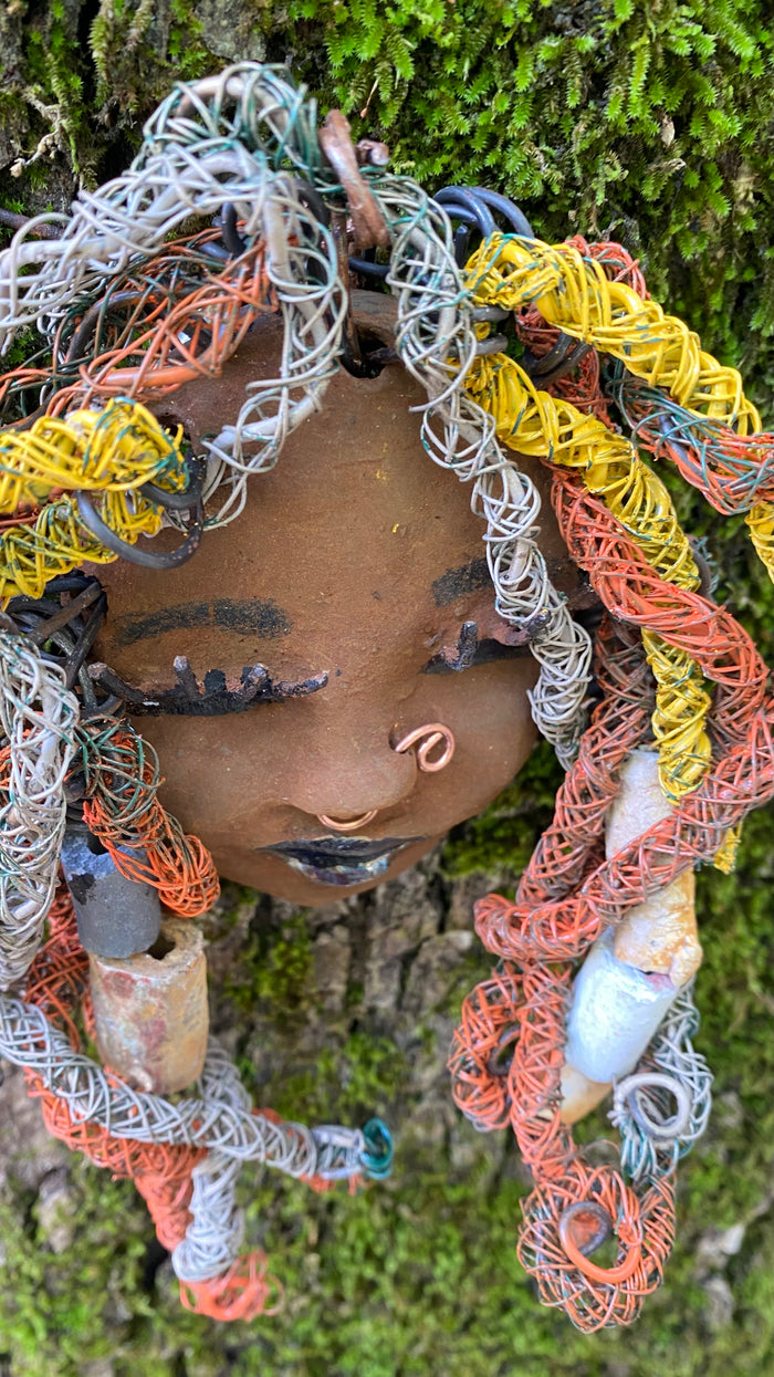 Introducing Nala, the 5" x 7" whimsical mask with a cocoa copper complexion. Its handmade textured dreadlocks and coiled 16 gauge wire provide a unique look that's not found in typical masks. Nala is the perfect conversationalist for your wild inquiries, so don't hesitate - give her a shout! My art journey began after I visited the Smithsonian Museum of African Art, and I was inspired to create Nala.
