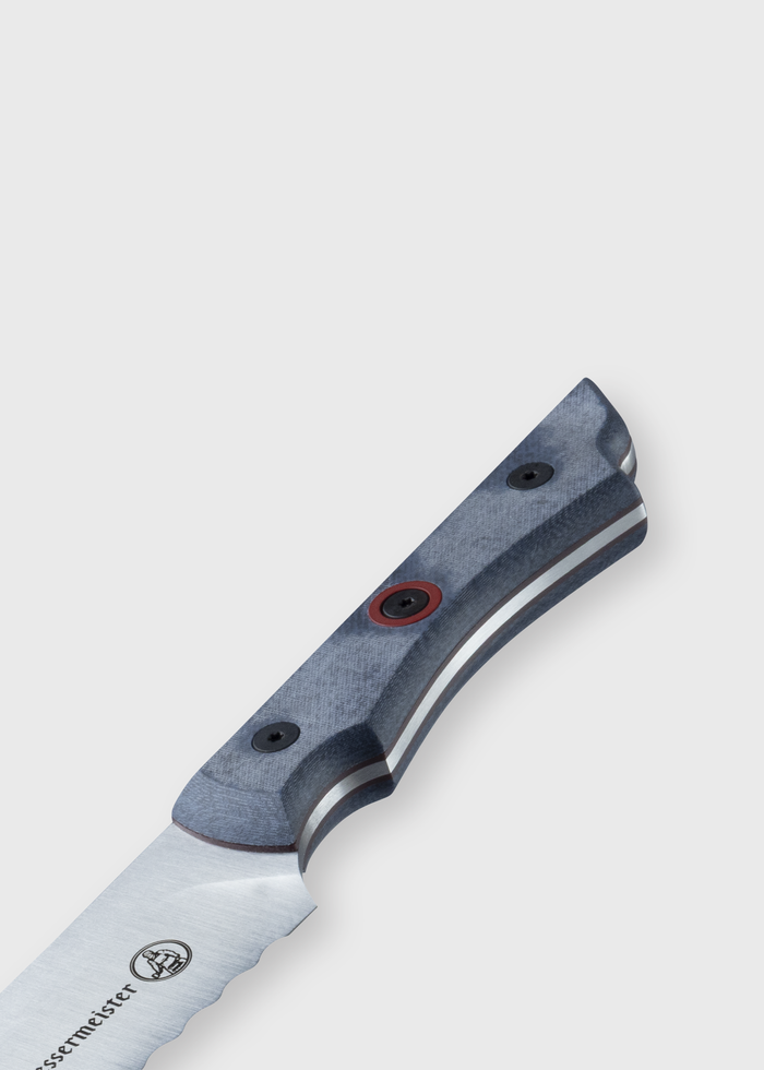 Close-up of a serrated knife with a textured handle and visible screws, showcasing its detailed craftsmanship and design.