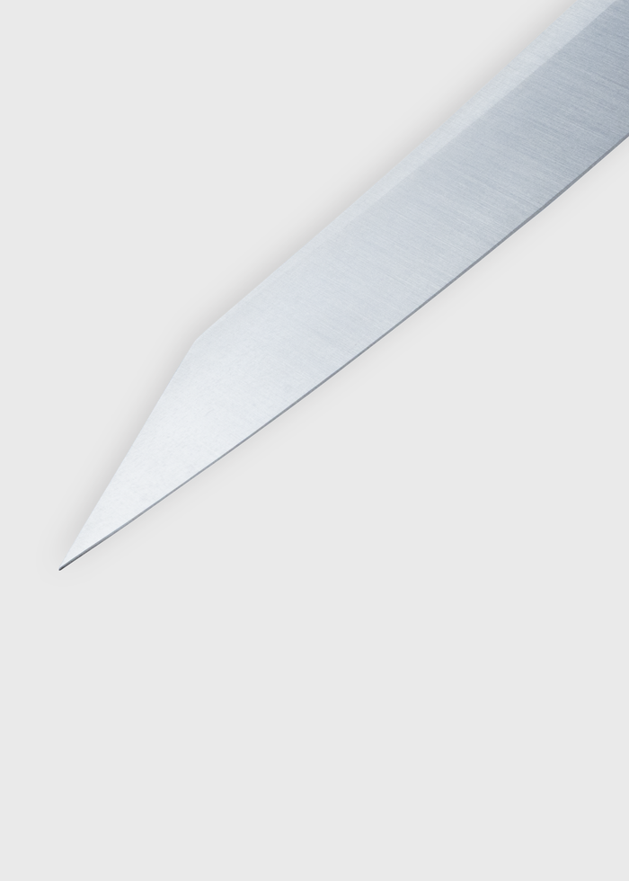 Close-up of a sharp, silver knife blade on a plain white background, highlighting its pointed tip and sleek design.