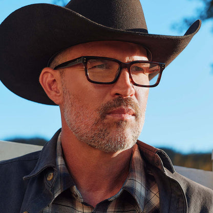lifestyle - male with cowboy hat wearing yellowstone x diff eyewear featuring the john dutton rectangle prescription glasses with a sequoia tortoise frame front view