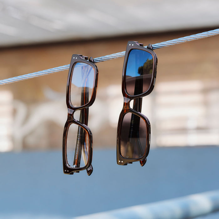 still life of yellowstone x diff eyewear featuring the john dutton rectangle glasses with a sequoia tortoise frame front view