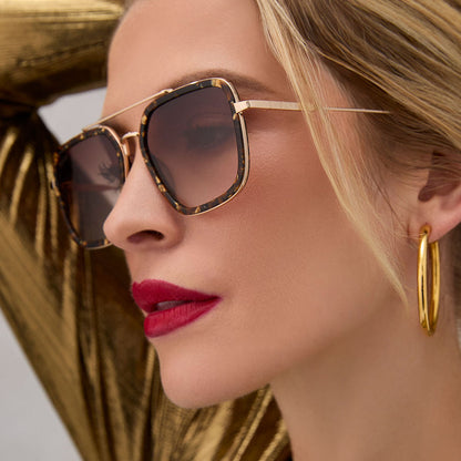 on model - female wearing diff eyewear featuring the jordan navigator sunglasses with a glitter tortoise frame and brown gradient lenses angled view