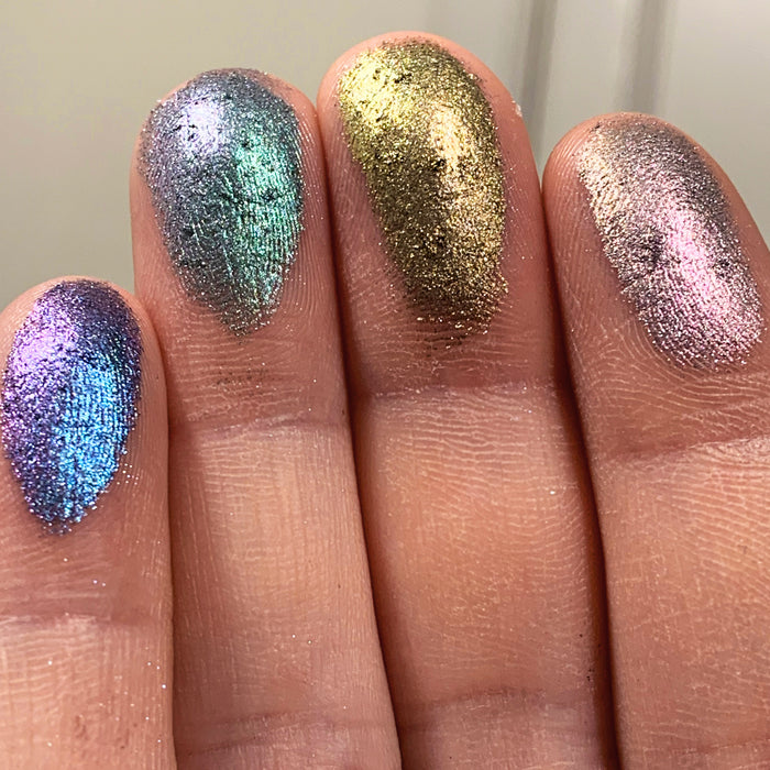 Right angled close up finger swatches of Keystone Pastel Multichrome Eyeshadow shifts next to Tower, Cathedral, Turret