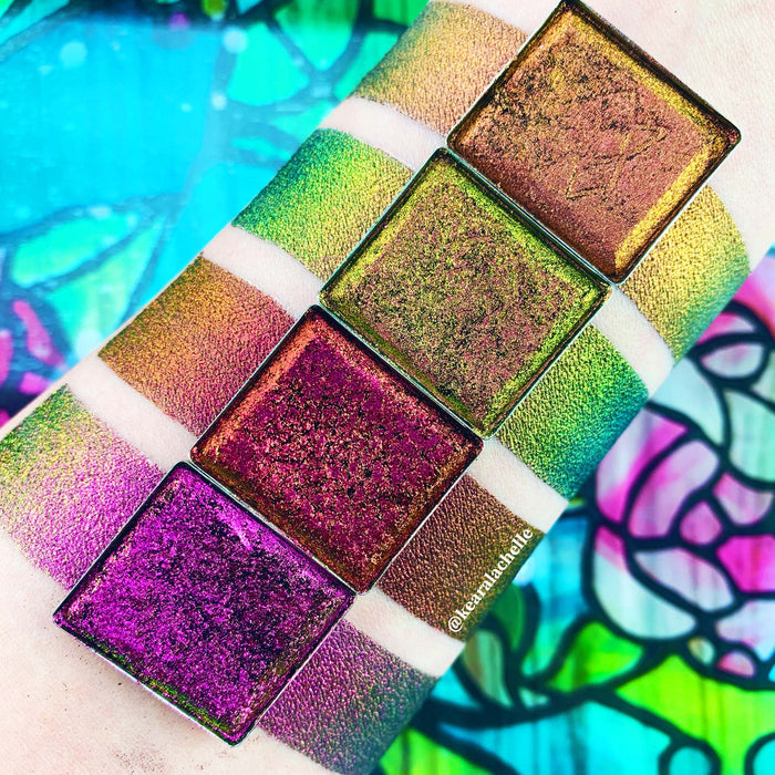 Top angled Kiln Jewelled Multichrome Eyeshadow overtop arm swatches on fair skin tone compared to Sand Blast, Forge, Smoulder