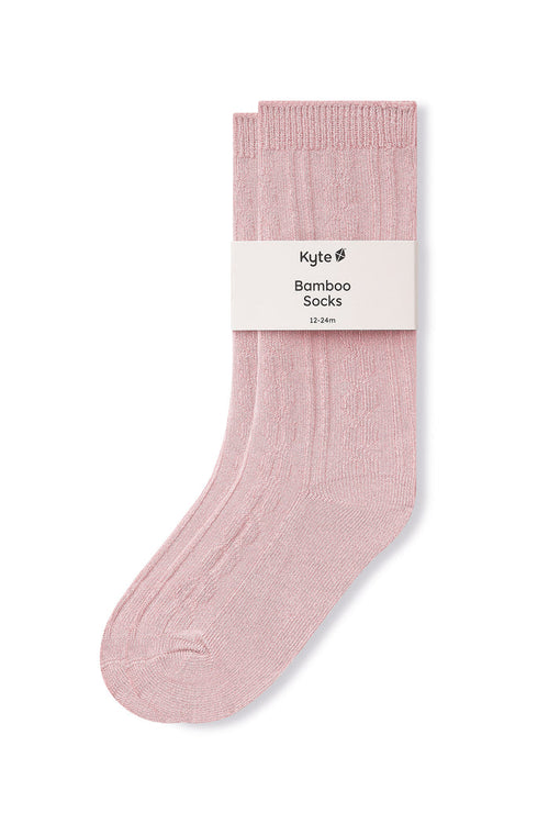 Knee high socks in blush laying flat on a white background.