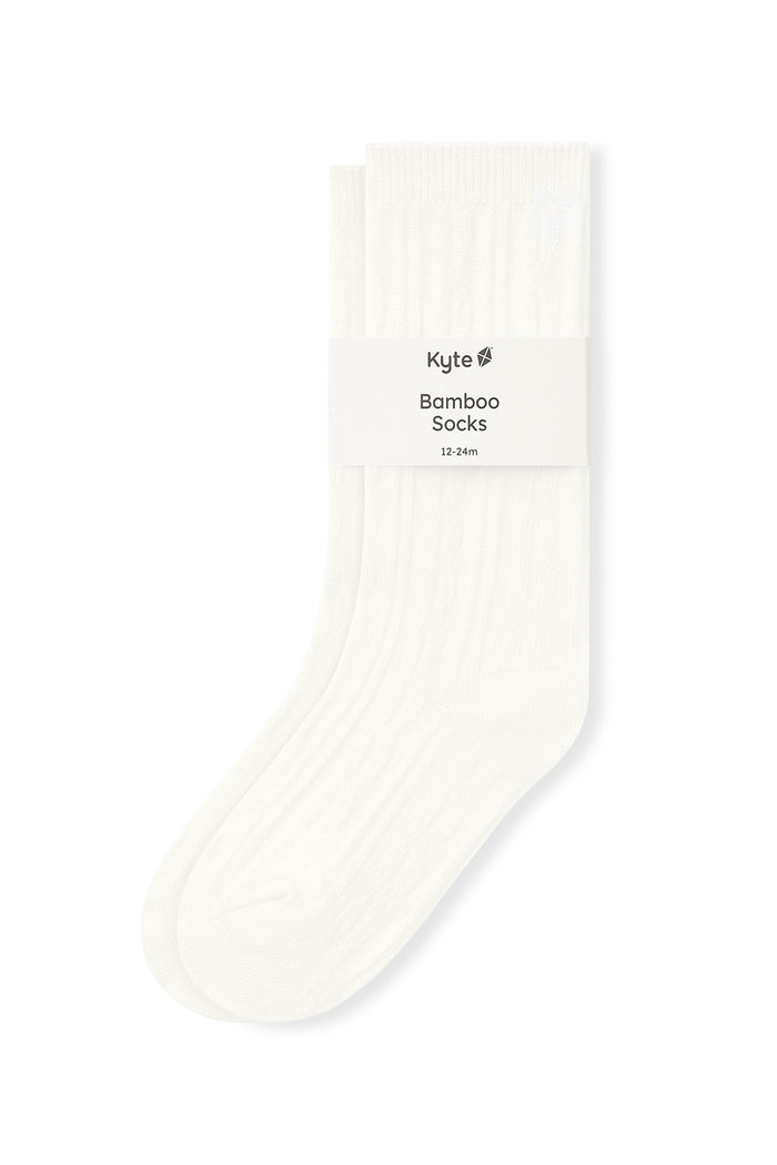 Knee high socks in cloud laying flat on a white background.