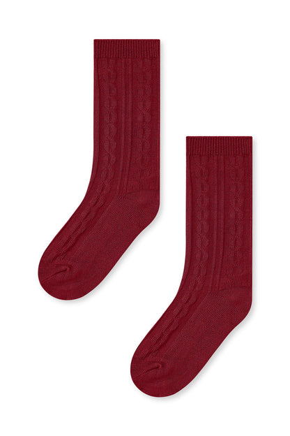 Knee high socks in ruby laying flat on a white background.
