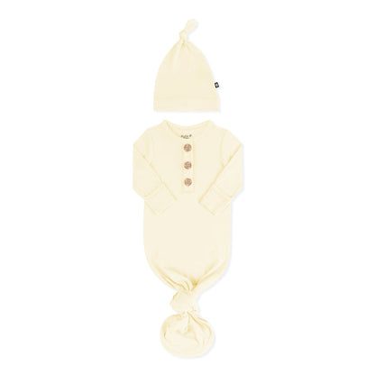 Knotted Gown with Hat Set in Chamomile with the arms folded inward