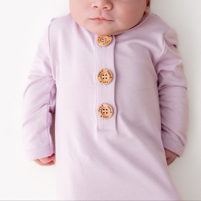 Close up of newborn wearing the Knotted Gown with Hat Set in Thistle