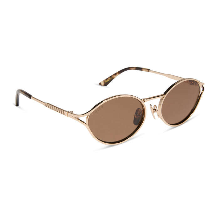 jessie james decker x diff eyewear featuring the limoncello oval sunglasses with a gold frame and brown lenses angled view
