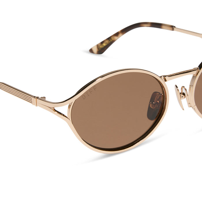 jessie james decker x diff eyewear featuring the limoncello oval sunglasses with a gold frame and brown lenses detailed view