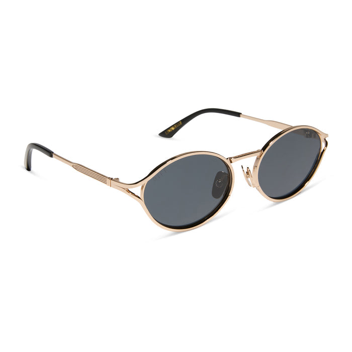 jessie james decker x diff eyewear featuring the limoncello oval sunglasses with a gold frame and grey lenses angled view