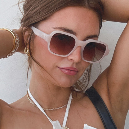 lifestyle - aspyn ovard x diff eyewear female wearing the lola square prescription glasses with a milky blush frame angled view
