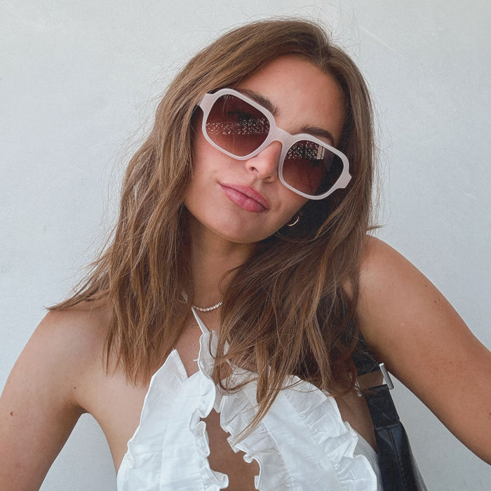 lifestyle - aspyn ovard x diff eyewear female wearing the lola square prescription glasses with a milky blush frame front view