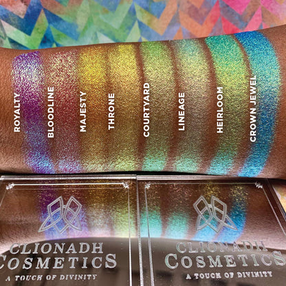 Top angled arm swatches on deep skin tone of Majesty Vibrant Multichrome Eyeshadow shifts next to Crown Jewel, Heirloom, Lineage, Courtyard, Throne, Bloodline, Royalty