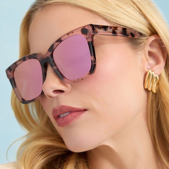 lifestyle - female wearing diff eyewear meredith square sunglasses himalayan tortoise & light pink mirror angled view