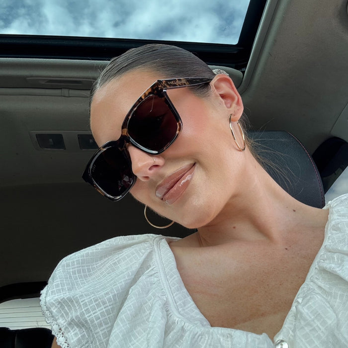 lifestyle - abigail gherring wearing brown tort square sunglasses