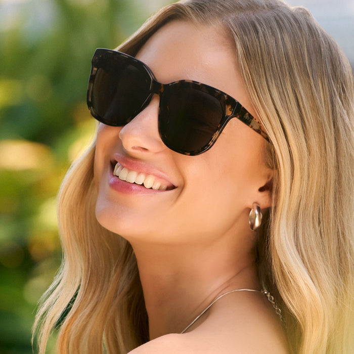 lifestyle - female wearing diff eyewear featuring the meredith ii square sunglasses with a espresso tortoise frame and brown gradient lenses detailed view