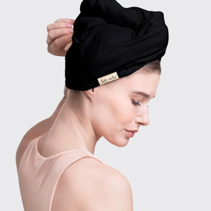 Side view of model wearing the Black Microfiber Hair Towel.