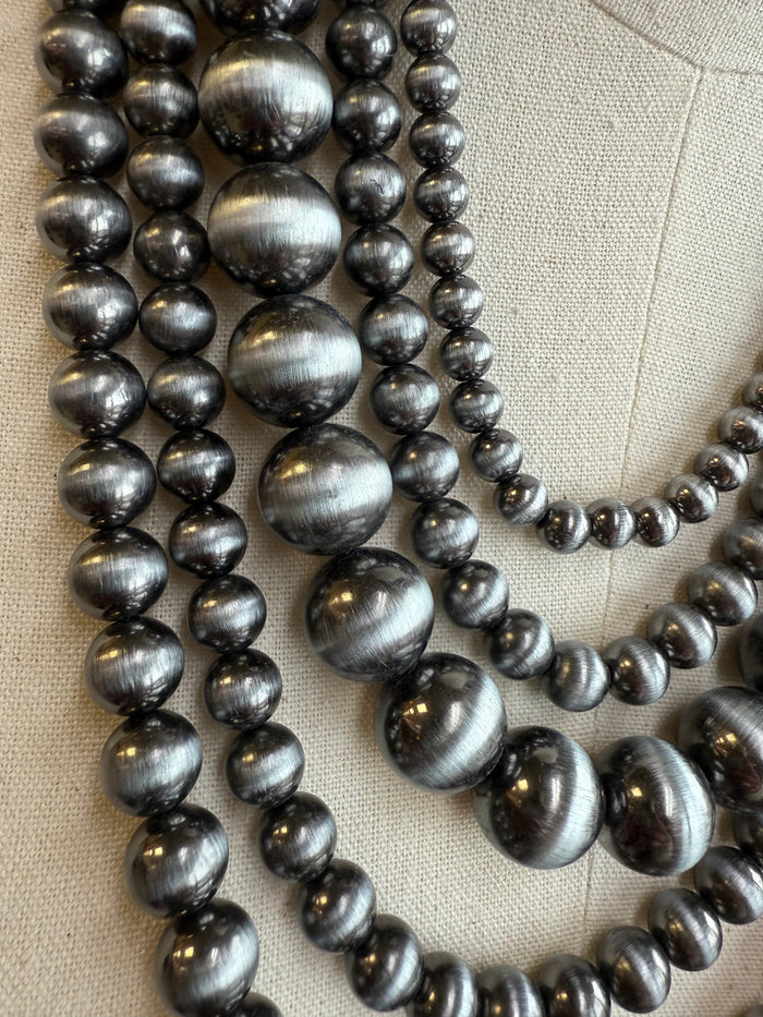 Graduated metallic gray pearl necklace with multi-layer drape, close-up bead rows