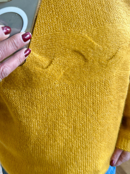 Mustard knit fabric close-up, fine textured weave
