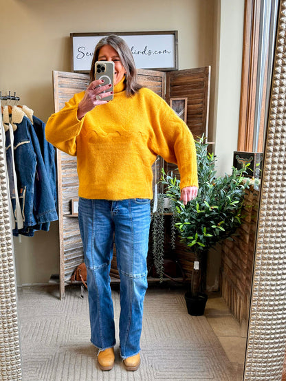 Mustard cable-knit turtleneck sweater with long sleeves, relaxed fit