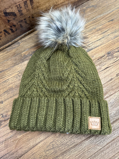 Olive cable knit pom beanie with ribbed cuff and woven patch tag